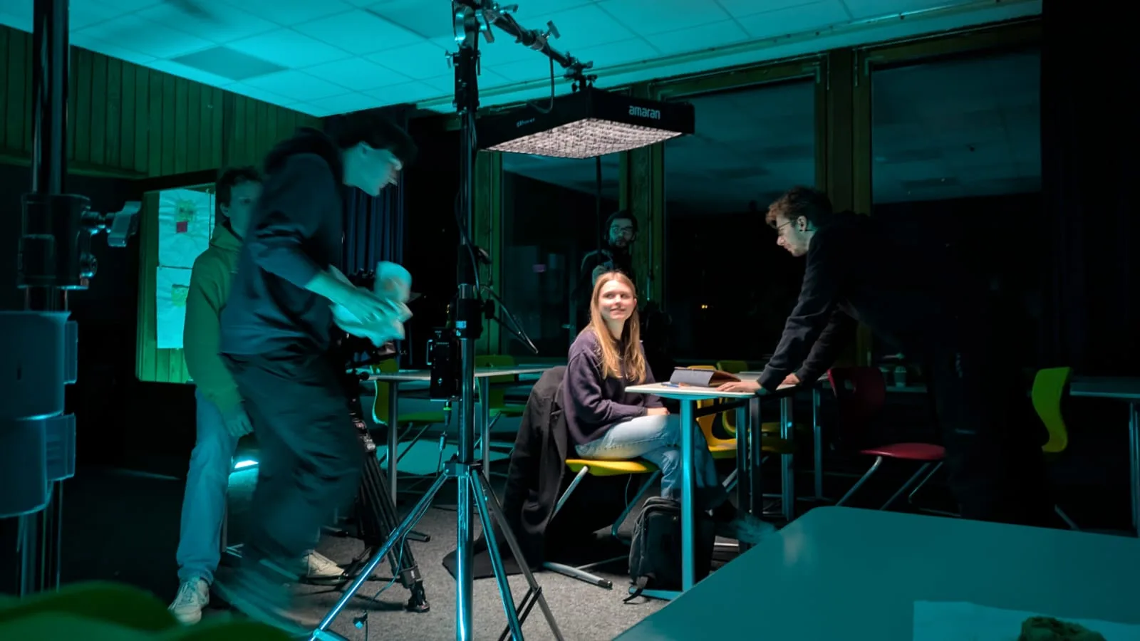 Vorbereitung einer Szene am Set von „Crisis“ - Crewmitglieder besprechen die nächsten Einstellungen, Kamera und Licht sind bereitgestellt.